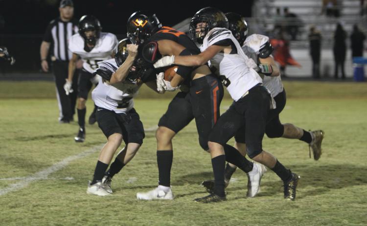 It took three players plus another on the way to stop Lindsay Leopard #25 Seth Padilla, but not before he got first-down yardage in last Thursday's game with Marietta. Photo courtesy of Sheryl Kochert.