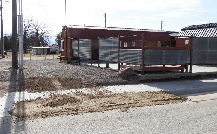 The town of Maysville has agreed to remove a section of new curbing that is blocking the graveled drive-thru at Toodles Tacos. The curb was installed in November as part of a sidewalk project along Main Street. In return for removing the curb, the town has asked the business to remove part of the metal fencing at the end of the drive-thru to improve visibility. News Star Photo by Chris Mackey.