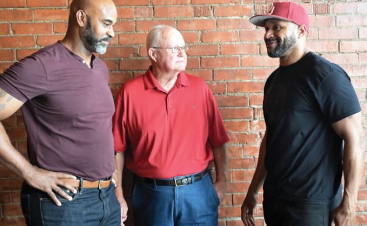 Former Wynnewood coach Jim Holloway (center) visits with Wynnewood football alumni Dale Allen (left) and James Allen (right) during a May 23 reception to honor Holloway's years of dedication to the Wynnewood football program. News Star photo by Don Coffey