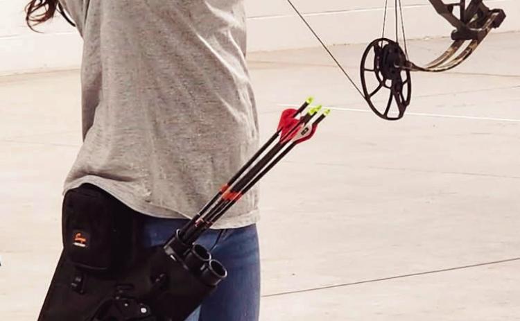16-year-old Paetyn Woodring of Wynnewood aims her compound bow during a 4-H archery competition. Photo provided by April Woodring