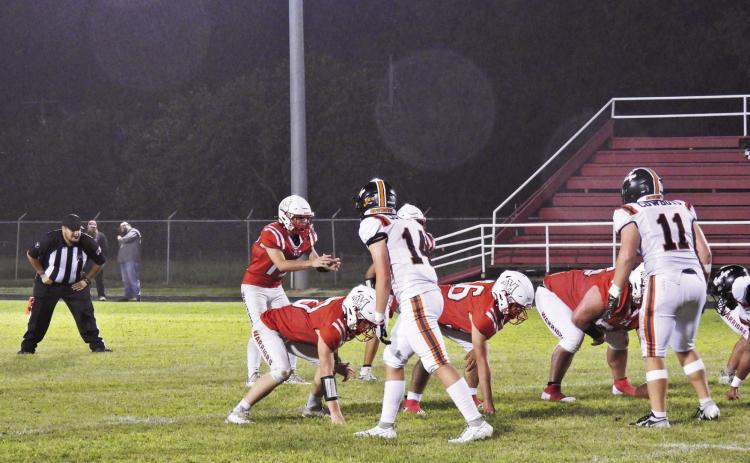 Maysville‘s Ryan Johnson awaits the snap of the ball in the game against Ryan Aug. 29. The Warriors lost the rainy Friday night game to the Cowboys, 46-0. News Star phooto by Chris Mackey