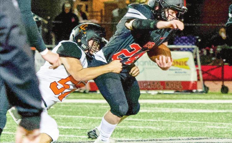 Leopard Owen Simonton tackles the Knights running back during the second round playoff game last Friday. Photo by Kristy Schrader