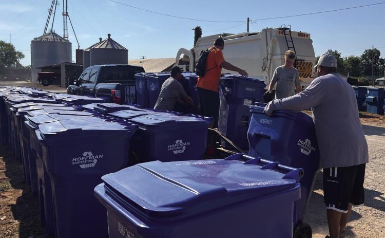 Crews with Hoffman Sanitation worked to distribute polycarts to residential addresses across Maysville Saturday morning. News Star photo by Suzanne Mackey