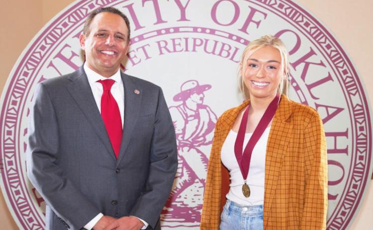 Claire Kendall, Pauls Valley, is one of 56 students set to graduate from OU in December who were recently honored for maintaining a perfect 4.0 grade-point throughout their undergraduate studies. Kendall is pictured with OU President Joseph Harroz Jr.