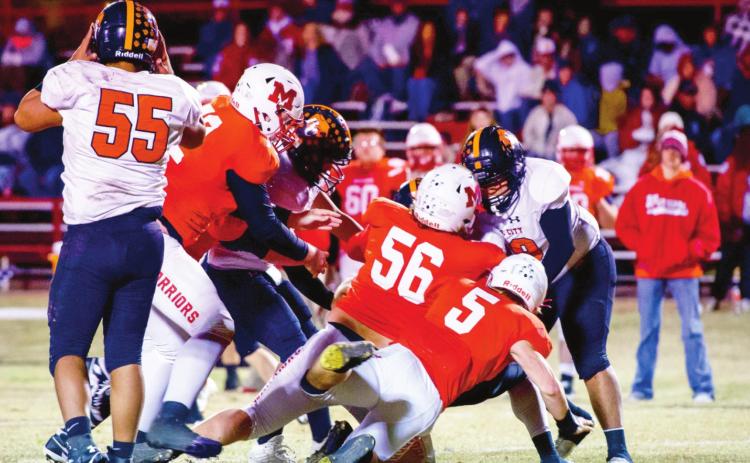 Maysville's Benson Larson, Kolby Wyatt and Nigel Reid work together to tackle the Boise City running back during last Friday’s game. Photos by Kristy Schrader