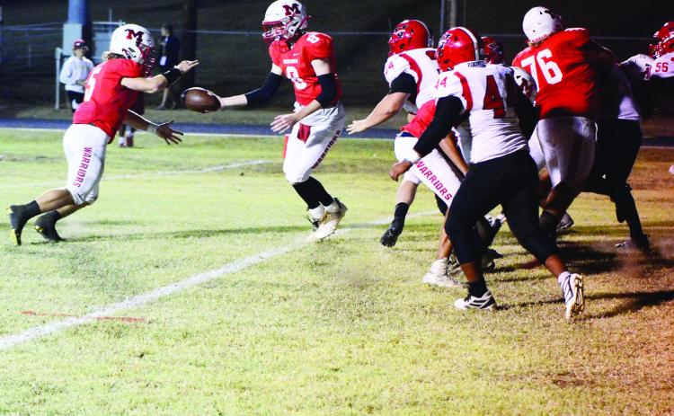 Maysville Warrior Bo Green hands the ball off to Nigel Reid in the game last week against Sasakwa. Maysville ended the game at halftime with a mercy rule call after widening the lead by more than 45 points. The final score was 56-0. Photo by Denny Park