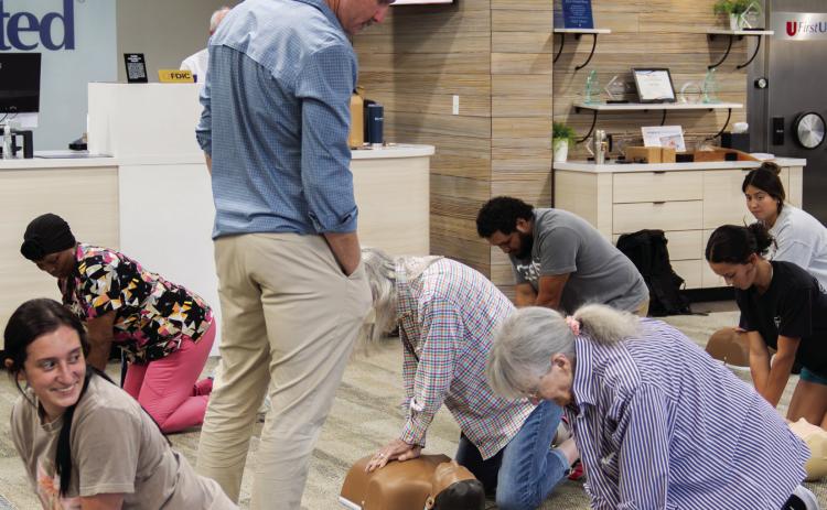 Community members practice their CPR skills during a recent CPR Certification class at First United Bank in Pauls Valley. The bank plans to offer the certification class to the community again in the spring. Photo courtesy of First United Bank