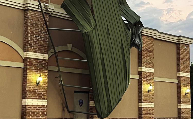 Tuesday’s storms left this carport perched precariously on the front of the Pauls Valley Police Department. The structure was originally located in a fenced area on the PVPD property, adjacent to the building. News Star photo by Suzanne Mackey