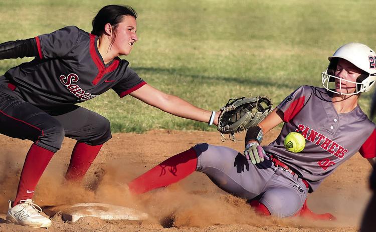 Pauls Valley’s Raegan Close takes a ball off the gut as she slides into third during action with Wynnewood Monday in the Wayne Festival. Photo by Mike Arie