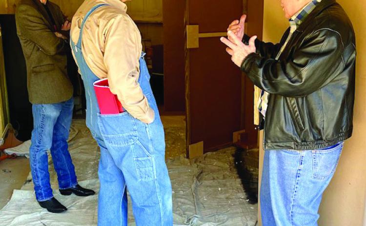 Artist Kevin Stark, engineer Gary Koch and Garvin County Choral Society and Sinfonietta artistic director Jack Bowman confer about the set design for the upcoming presentation of "Amahl and the Night Visitors" to be held Dec.10 at 7 p.m. at the First Presbyterian Church in Pauls Valley. Courtesy Photo