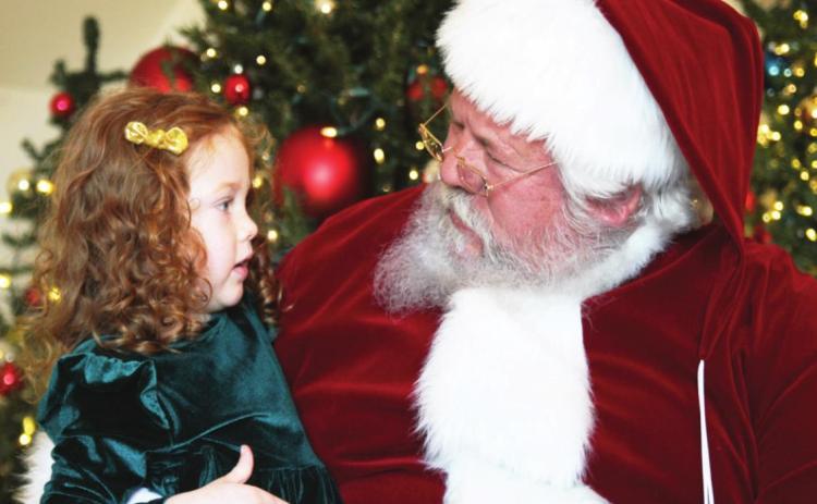 Little Miss Johnson had a heart to heart talk with Santa during her visit to the Murray-Lindsay Mansion for the Lindsay Community Historical Society's Christmas Fundraiser on Dec. 5. Photo courtesy of Sheryl Kochert