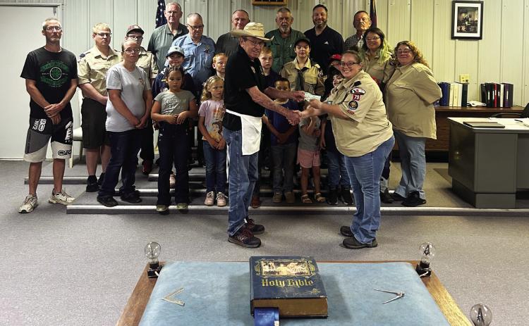 Wynnewood freemasons and cub scouts gathered this week for a check presentation. Roger Poyner, worshipful master of Wynnewood Masonic Lodge 40, presented Jana Smith, scout leader for Wynnewood Cub Scout Pack 79, with a fundraising check after the two organizations partnered May 8 for a very sucessfull pulled pork sandwich fundraiser in downtown Wynnewood. Courtesy photo