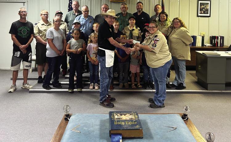 Wynnewood freemasons and cub scouts gathered this week for a check presentation. Roger Poyner, worshipful master of Wynnewood Masonic Lodge 40, presented Jana Smith, scout leader for Wynnewood Cub Scout Pack 79, with a fundraising check after the two organizations partnered May 8 for a very sucessfull pulled pork sandwich fundraiser in downtown Wynnewood. Courtesy photo