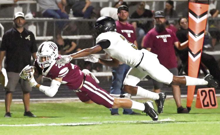 Wynnewood‘s Gabe Maddox dives for the goal line Friday night as the Savages routed the Allen Mustangs 31-14. News Star photo by Don Coffey