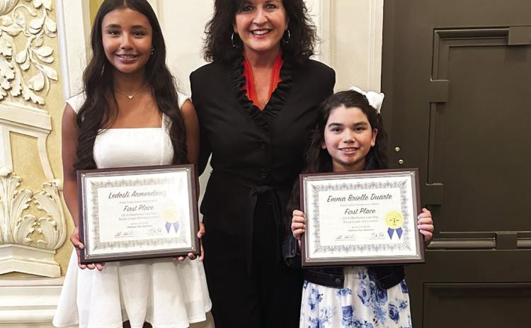 Pauls Valley students Ledesli Armendariz (left) and Brielle Duarte (right), pictured here with State Representative Tammy Townley, were among the Oklahoma Bar Association’s 2024 Law Day Art and Writing Contest winners recognized during a ceremony at the State Capitol April 4. Armendariz won first place in the ninth-grade writing contest, and Duarte won first place in the third-grade art contest.