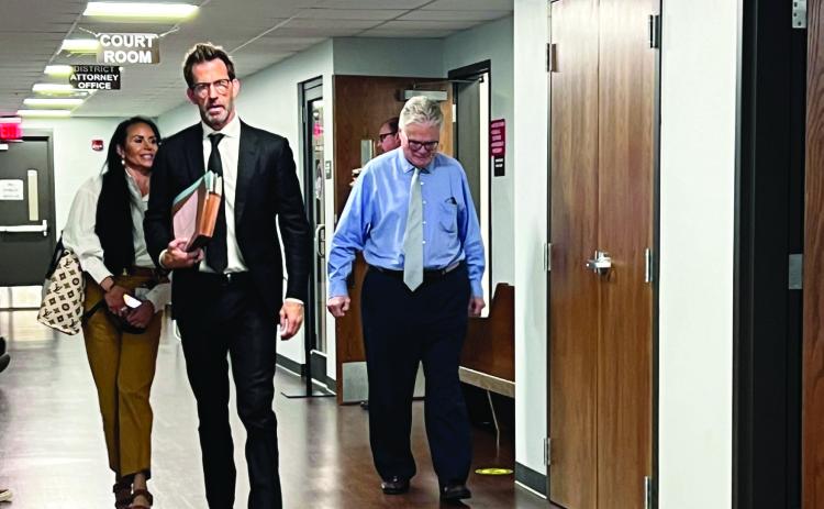 Dr. Edward Hallowell (far right) walks out of a Garvin County courtroom Wednesday with his attorney Josh T. Welch after being arraigned on three felony counts. News Star photo by Suzanne Mackey