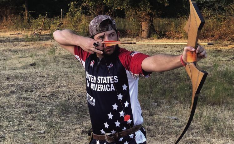 Shiloh Butts takes aim at a target in his USA team uniform. Photo courtesy of Chickasaw Nation.