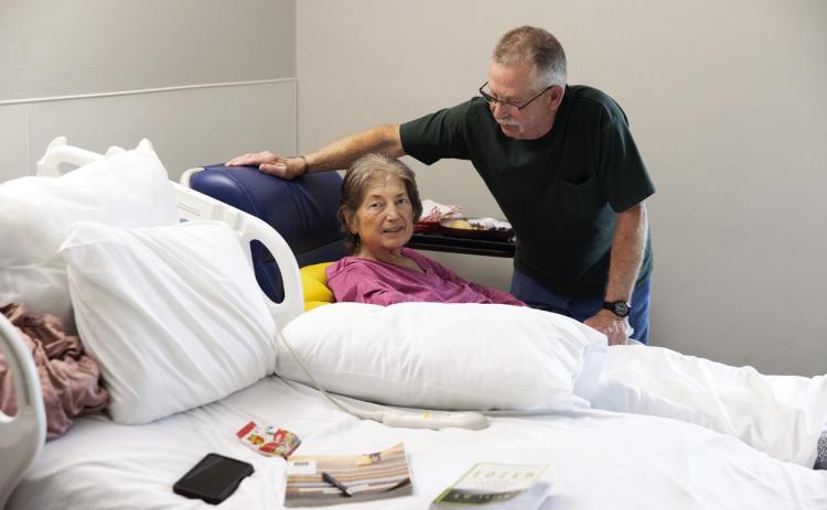 Mike McGuire talks with his wife, Kim McGuire, during her stay at Rural Wellness Stroud hospital in Stroud on April 21, 2026. It's one of several rural hospitals finding ways to adapt and avoid closure. (Brent Fuchs/Oklahoma Watch)
