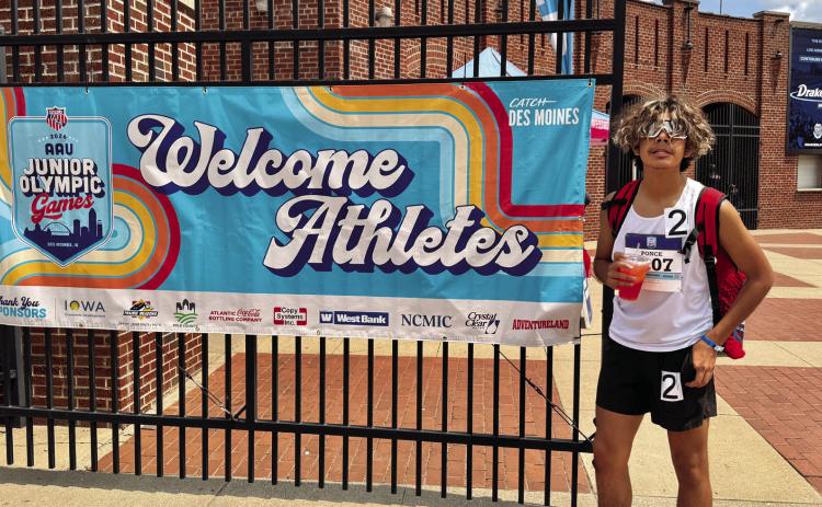 David Ponce stands in front of the athlete entrance for the AAU Junior Olympic Games, where he qualified for the 800-meter run. Courtesy photo