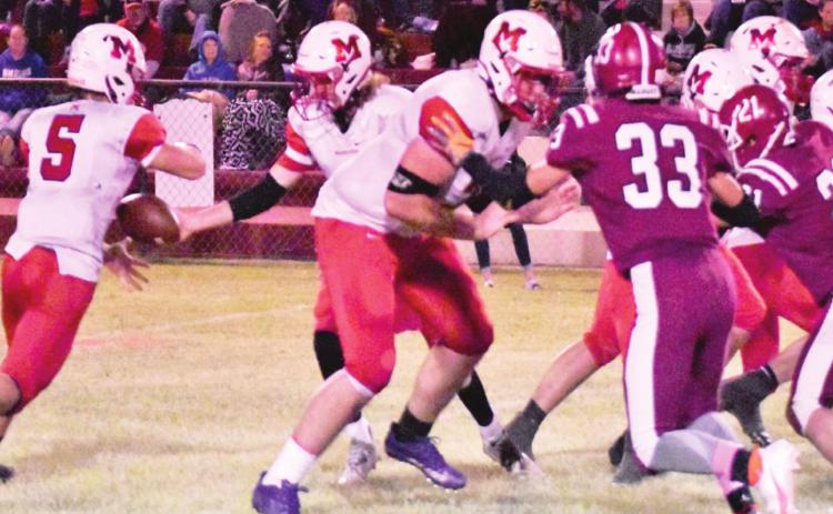 Bo Green hands the ball off to Nigel Reid during last Friday night’s game against Mt. View-Gotebo. 