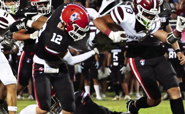 Wynnewood’s #13 Briar Davenport goes airborn for extra yards as #11 Phoenix Sparks runs in to help in Wynnewood’s 30-7 win over Christian Heritage Oct. 3. News Star photo by Don Coffey