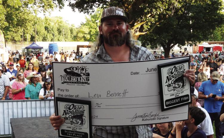 Levi Bennett won the top prize of Biggest Fish at Pauls Valley’s Okie Noodling Tournament Saturday. Bennett placed first in the tournament’s Scuba Division with a fish weighing in at 74.29 pounds. News Star photo by Chris Mackey