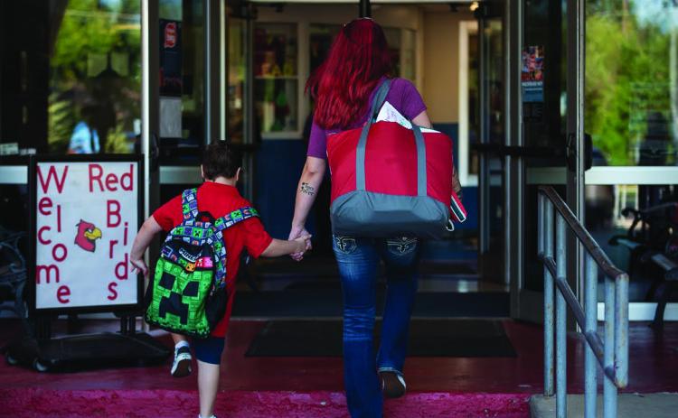 Students and parents walked into Monroe Elementary School in Oklahoma City on the morning of Aug. 11, 2022, the first day of school. (Whitney Bryen/Oklahoma Watch)