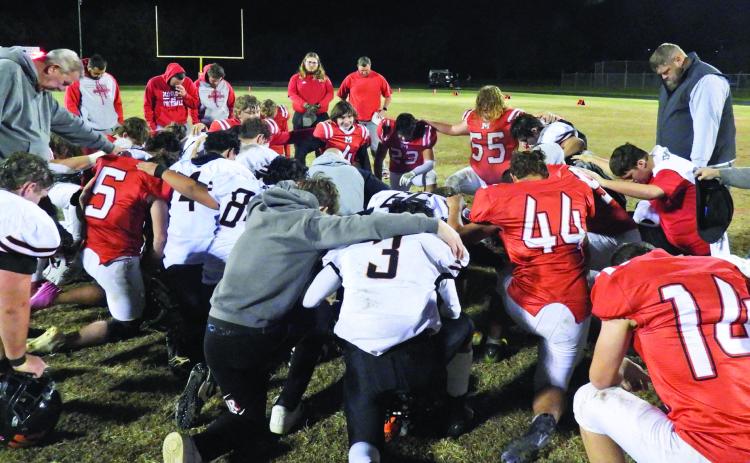 Players from Maysville and Watts came together for a post-game prayer after the first round of OSSAA playoffs Nov. 15. The Warriors defeated Watts, 68-20, moving into the second round this week to play Tyrone at home. Tyrone is 8-2 on the season and advance to the second playoff round after beating Geary, 56-6. News Star photo by Chris Mackey