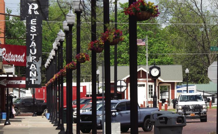 Hanging baskets were installed on lampposts along Paul Avenue over the weekend to add a little color to the downtown landscape. News Star photo by Suzanne Mackey