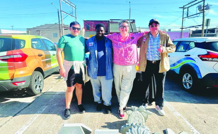 The ECU Glass Recycling team at their booth at the Ada's Farmers Market, showcasing their unique concrete pavers made from recycled glass.
