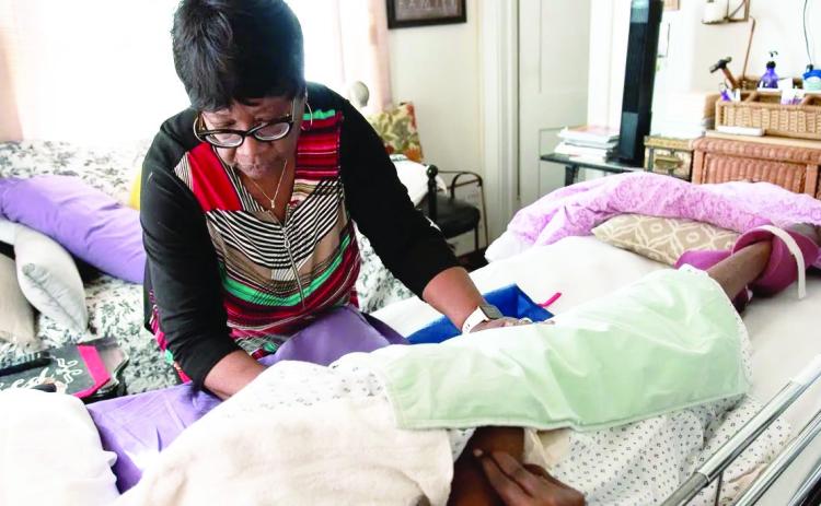 Oklahoma City resident Francis Johnson, 64, left, retired early to for her 89-year-old mother full time after three strokes left Maybelle Thomas Fisher bedridden and unable to speak. (Whitney Bryen/Oklahoma Watch)