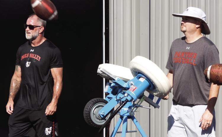 Pauls Valley assistant football coach Wakley Bergner (right) demonstrates Pauls Valley’s new JUGS machine during practice at Thompson Field Tuesday morning. The automated passing and kicking machine can deliver up to 600 passes or kicks an hour, allowing players to get in plenty of repetitions as they develop their skills. News Star photo by Chris Mackey