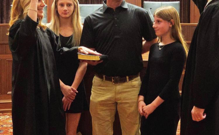 Kristin Jarman takes her oath of office as associate district judge for Murray County at the State Capitol earlier this month. Jarman, far left, was accompanied during the ceremony by her husband and two of her daughters. Courtesy photo
