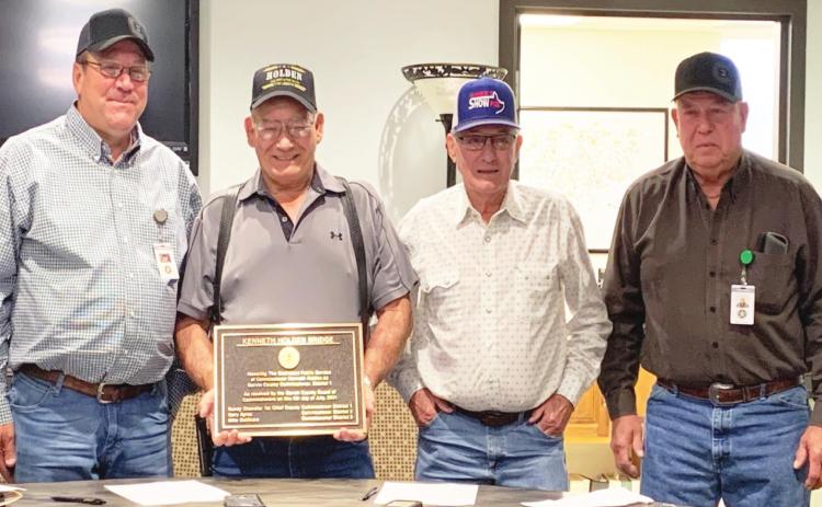 A new bridge over Rush Creek in the western part of Garvin County will be named the Kenneth Holden Bridge in honor of retired Garvin County Commissioner for Dist. 1 Kenneth Holden. A bronze plaque that will eventually be installed on the bridge was presented to Holden at the Garvin County Board of Commissioners' regular meeting Monday. Pictured left to right are Dist. 3 Commissioner Mike Gollihare, Holden, Dist. 2 Commissioner Gary Ayers and Dist. 1 Commissioner Randy Chandler.