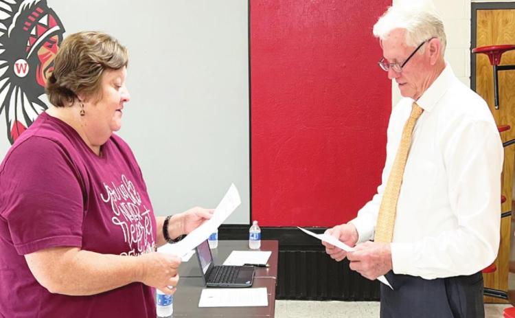 Belinda Hunt was sworn in and took her seat on the Whitebead Board of Education Monday. The oath of office was administered by Whitebead Board of Education member Ed Tillery (right). Hunt was elected to the office April 5.