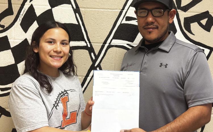 Aura Valenzuela of Lindsay is being awarded her scholarship check from MATC Automotive Service Technician teacher Alex Juardo. Courtesy photo