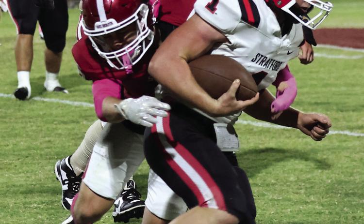 Wynnewood’s Braylon Pierce makes a hit on Stratford Joesph Smith during the Savages’ win at home Friday night. Photo by Mike Arie