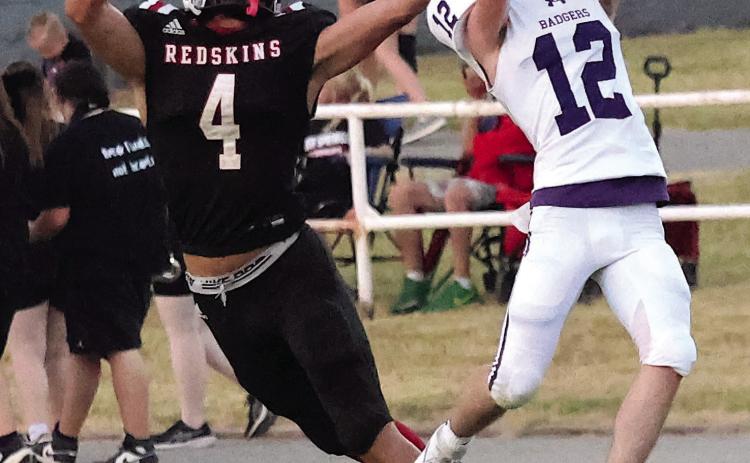 Elmore City-Pernell’s Jesse Cook goes up and intercepts a pass in front of Rush Springs’ Derrick Boyster during Friday’s 48-0 loss to the Redskins. Photo by Mike Arie