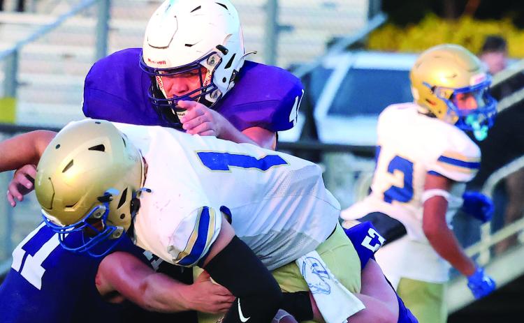 The Elmore City-Pernell’s defense of Owen McConnell (#11), Carston Lauderdale (#44) and Devin Stanley (#52) force a Central Marlow fumble during Thursday action at Wheeler Field. Photo by Mike Arie