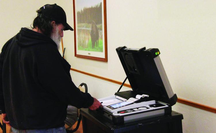 Gary Corn, 74, inserts his ballot into the voting machine during a special election on the adult use of recreational marijuana in Oklahoma, March 7, 2023, at a Del City Community Center polling station. Lionel Ramos/ Oklahoma Watch