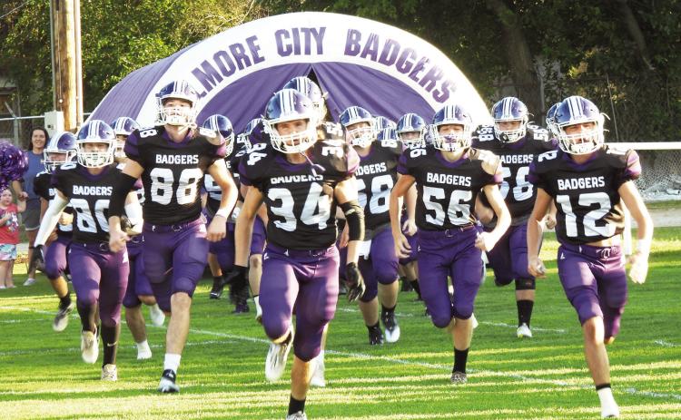 Elmore City-Pernell Badgers #34 Senior Will Balentine and #12 Junior Caleby Lauderdale lead the team onto Wheeler Field for the season opening game against the OKC Patriots. The Badgers lost a tough game against the Patriots 21-12. News Star photo by Chris Mackey