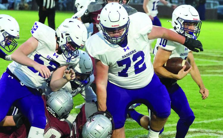 Elmore City-Pernell's Colt Matthews (#10) runs behind the block of Eli McConnell (#72) and Devin Stanley (#52) during Friday's game at Velma-Alma. Photo by Mike Arie