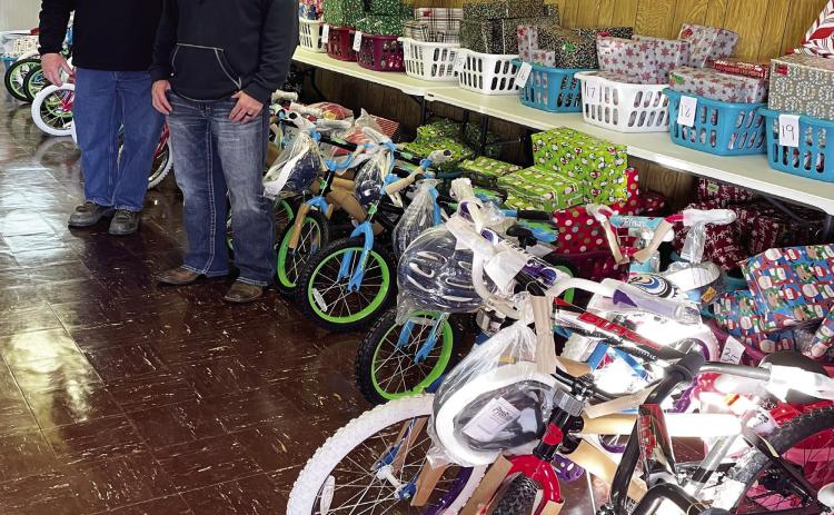 Terry Looney, OG&amp;E construction distribution area supervisor, and Harvey Fisher, OG&amp;E supervisor of area T&amp;D substation operations, delivered 20 brand-new bicycles to the Maysville Daughters Club in December. The bicycles were then distributed to deserving children in the community. Courtesy photo