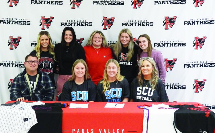 Pauls Valley seniors Madilyn and Caitlyn Hagood signed letters of intent Wednesday to play softball for Southwestern Christian University in Bethany. The sisters are pictured with their parents, Randy and Crystal Hagood, and their Pauls Valley softball teammates. News Star photo by Chris Mackey