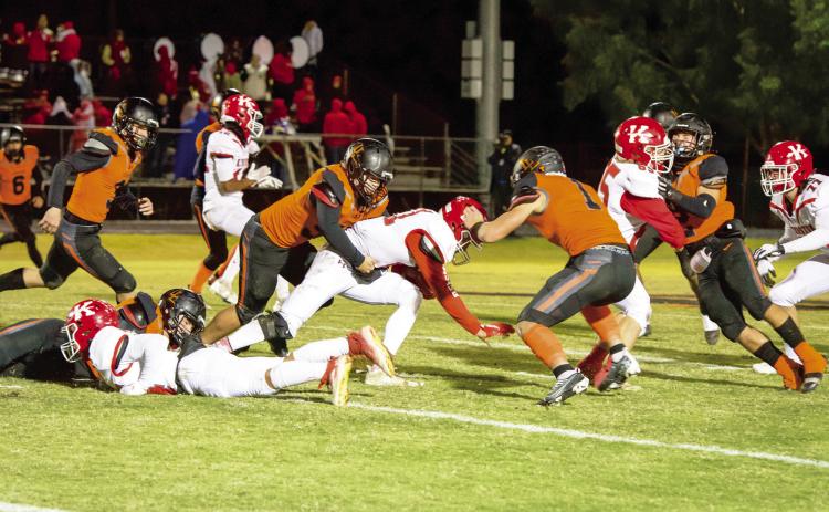 The Lindsay Leopard defense swarms the Kingston running back during last week's first round playoff win over the Redskins, 49-27. News Star photo by Kristy Schrader