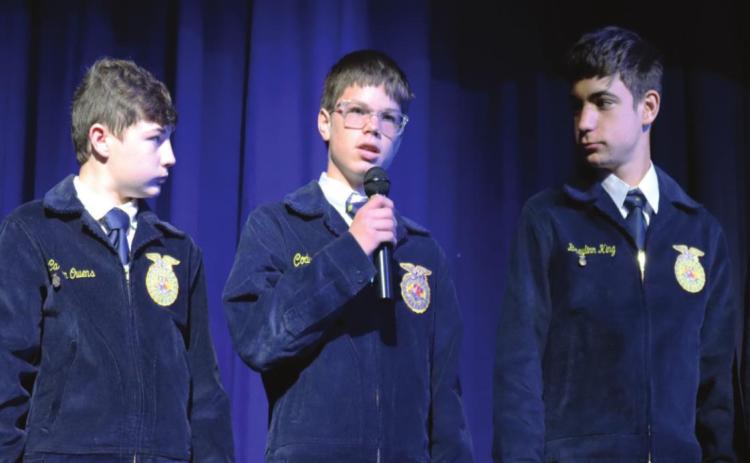 Stratford FFA member Braxton Bear gives a word of what a true veteran is, while Carson Owens and Braylin King look on. Photo courtesy of Halle Pullen