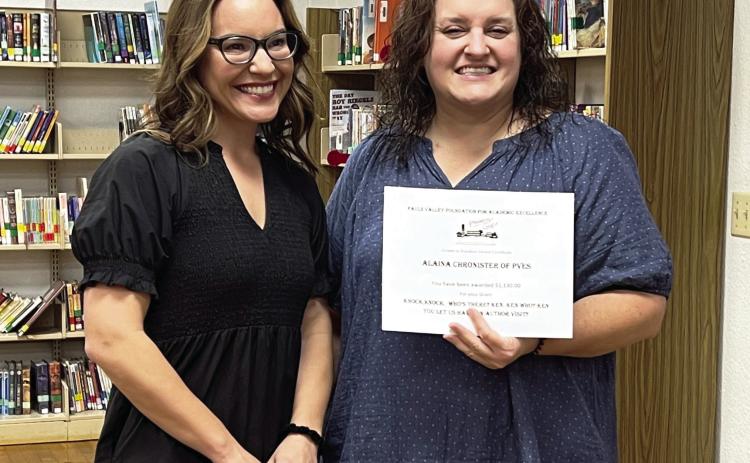Pauls Valley educator Alaina Chronister (right) was one of nearly 30 certified teachers from the Pauls Valley and Whitebead school districts who received 'Grants for Teachers' awards from the Pauls Valley Foundation for Academic Excellence Tuesday. Chronister was awarded three grants which will be used for materials and projects at Pauls Valley Elementary and Intermediate Schools. PVFAE board member Camille Milligan (left) presented Chronister with the grant awards.