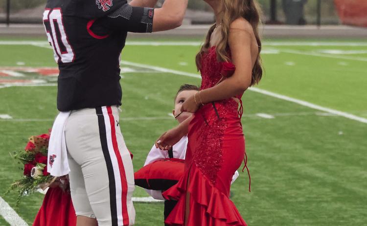 Pauls Valley Homecoming King Avery Cates crowns Kate Taylor Homecoming Queen before Friday’s game against Madill. Photo by Mike Arie