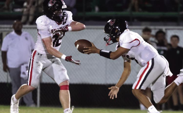 Pauls Valley quarterback Braylin Keller stumbles as he makes a handoff to tailback Brody Brown during the Panthers’ heartbreaking loss to Seminole Friday, Sept. 25. Photo by Mike Arie