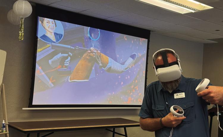 MATC Student Recruiting Coordinator, Michael Gustafson, using interactive vVR technology to simulate a knee surgery. Courtesy photo